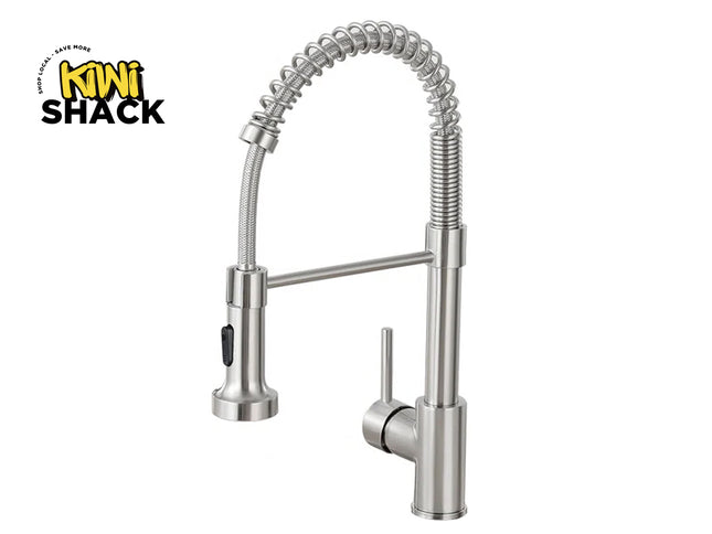 Brushed nickel / stainless steel commercial-style pull-down kitchen faucet with an open coil spring neck arch, pull-down spray wand with a black mode toggle switch, horizontal support bar, single-lever side control handle, rigid base body, and the Kiwi Shack logo watermark.