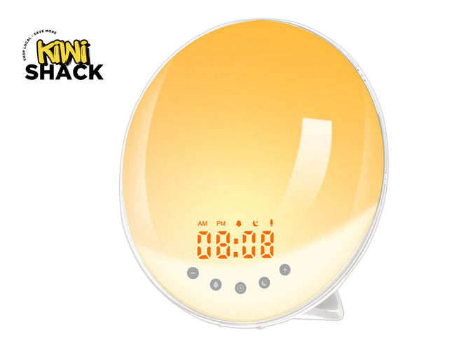 An oval Kiwi Shack LED light therapy pillow lamp glowing with a warm yellow-orange gradient, featuring a digital display showing 00:00 and five control buttons below, set against a plain white background with the Kiwi Shack logo in the top-left corner.