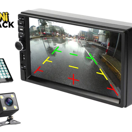 A car multimedia head unit and backup camera kit featuring a double-DIN stereo display with a rear-view parking guide overlay, a small cube-shaped backup camera with built-in LED lights, and a wireless remote control against a white background, with the "Kiwi Shack" logo in the upper left corner.