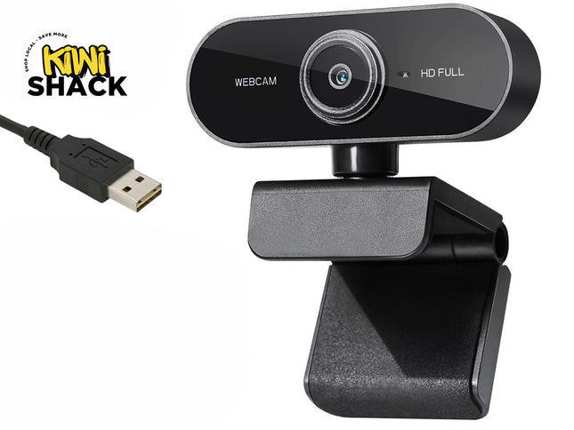 A black mini USB webcam with a clip-on stand, shown alongside its USB connector cable. The brand logo 'Kini Shack' is visible in the top left corner on a plain white background.