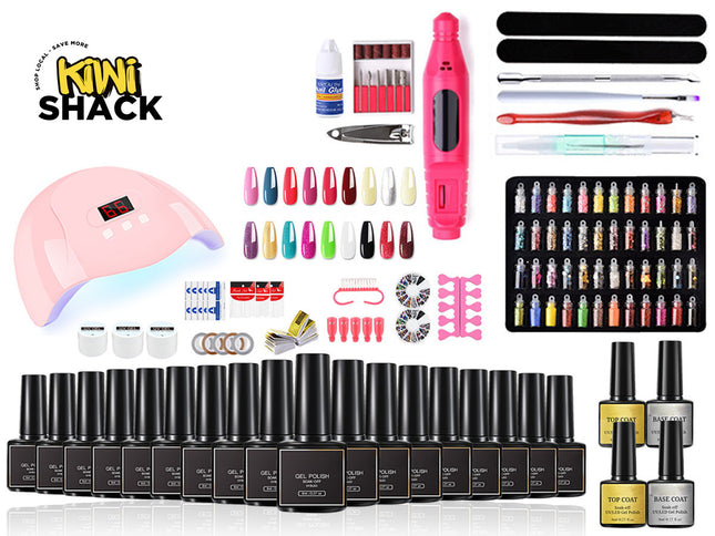 A comprehensive nail art kit by Kiwi Shack displayed on a white background, featuring a pink UV lamp, a pink electric nail file, a black tray of multicolor nail tips, a black tray of nail wraps, multiple black bottles of gel polish, and various application tools.