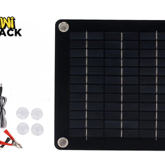 A square solar panel kit with four corner mounting grommets, accompanied by a cigarette lighter adapter cable, battery alligator clips, and four suction cups, with a "Kiwi Shack" logo in the top left corner.