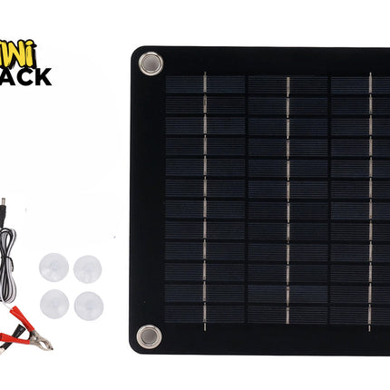 A square solar panel kit with four corner mounting grommets, accompanied by a cigarette lighter adapter cable, battery alligator clips, and four suction cups, with a "Kiwi Shack" logo in the top left corner.