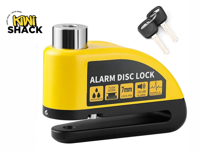 A bright yellow and black motorcycle alarm disc lock with a 7mm lock pin, waterproof casing, movement and shock sensor features, and two accompanying keys, featuring a "Kiwi Shack" logo in the top left corner.