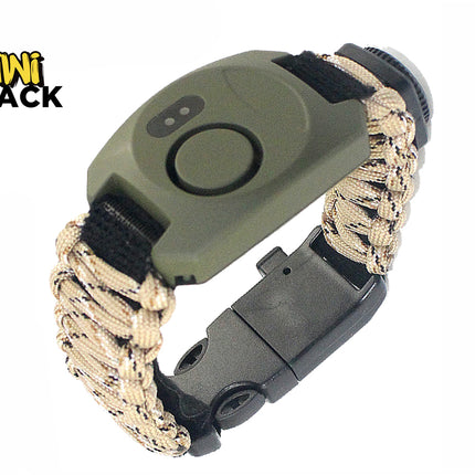 An olive green and tan paracord survival bracelet featuring an integrated digital compass, whistle, and a black plastic side-release buckle, with a "Kiwi Shack" logo in the top left corner.