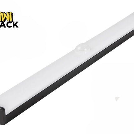 A slim, elongated LED under-cabinet light bar with a black base and a frosted white cover featuring a small motion sensor dome in the center, and a charging port visible on the end cap, with a "Kiwi Shack" logo in the top left corner.
