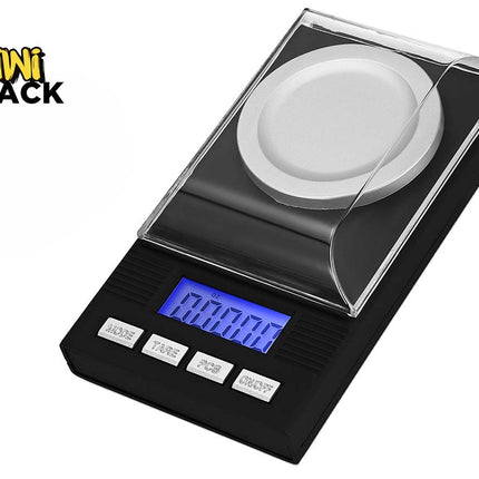 A black digital pocket scale with a clear protective cover, a silver weighing platform, and a blue backlit LCD display, shown on a white background with the Kiwi Shack logo in the top-left corner.