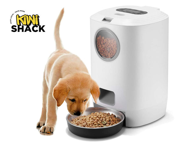 Dog eating from a bowl next to a white pet feeder with 'Kiwi Shack' branding.