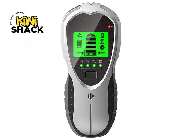 A silver and black digital electronic wall stud finder featuring an active green backlit LCD screen, mode indicator lights, and ergonomic grips, set against a white background. A "Kiwi Shack" logo appears in the top-left corner.