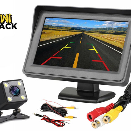 A car backup camera kit with a dashboard display monitor showing parking grid lines, a square LED backup camera, and connection cables, featuring the "Kiwi Shack" logo in the top-left corner.
