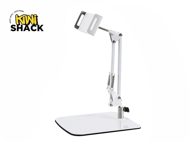 A white articulated desktop arm stand for a phone or tablet, featuring a heavy flat base, an adjustable spring-assisted mechanical arm, and a secure mounting clamp at the top, set against a plain white background with the "Kiwi Shack" logo in the top left corner.