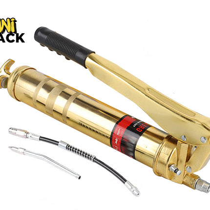 Gold-tone heavy-duty lever-action grease gun with a black-gripped manual handle, accompanied by a flexible black hose attachment and a rigid metal extension nozzle, branded with the "Kiwi Shack" logo in the top-left corner.