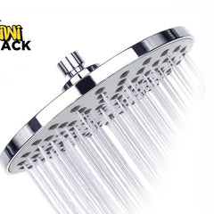 A chrome rainfall shower head with water actively spraying from its nozzle holes, featuring the "Kiwi Shack" logo in the top-left corner.