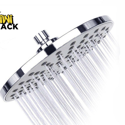 A chrome rainfall shower head with water actively spraying from its nozzle holes, featuring the "Kiwi Shack" logo in the top-left corner.