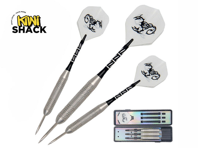 Set of three steel-tipped darts with knurled silver barrels, black patterned shafts, and white flights featuring a tribal scorpion graphic, shown alongside an open black hard-shell storage case, featuring Kiwi Shack logo in top left.