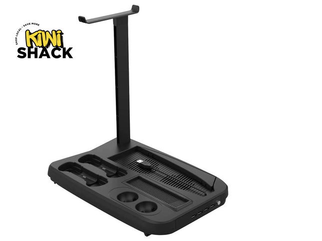 A black multi-function gaming headset stand and controller charging dock with an integrated vertical headphone holder, controller slots, a ribbed desk organizer base, and front USB ports, featuring a "Kiwi Shack" logo in the top left corner.