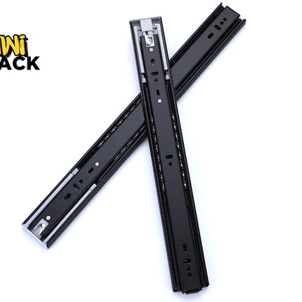 Pair of black heavy-duty full-extension ball-bearing drawer slides crossed over one another, showing mounting hole patterns, metal ball bearings in side raceways, plastic/metal release tabs/stops, and the Kiwi Shack logo watermark
