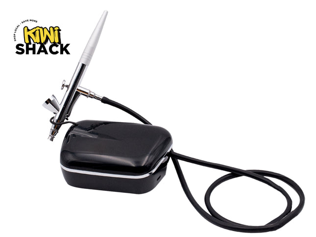 Black airbrush with cable on a white background, featuring Kiwi Shack logo.