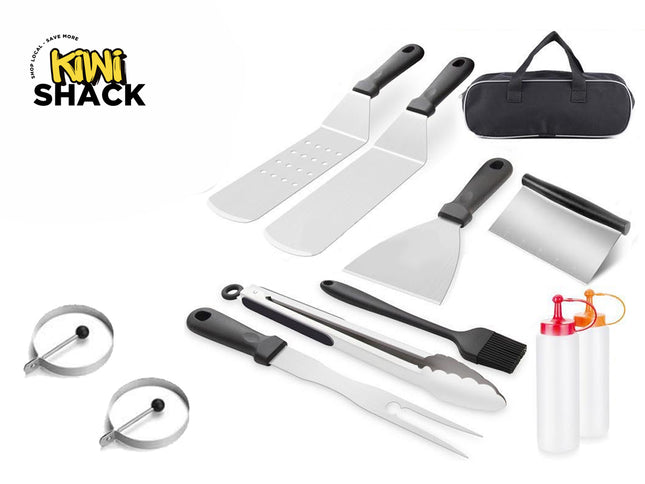 A flat lay of a stainless steel griddle and BBQ tool set on a white background, including two spatulas, a scraper, a bench knife scraper, metal tongs, a basting brush, a grilling fork, two egg rings, two squeeze bottles, and a black carrying bag, featuring a "Kiwi Shack" logo in the top left corner.