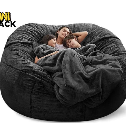 Large dark gray bean bag chair with a family of four wrapped in a blanket, branded 'Kiwi Shack'.