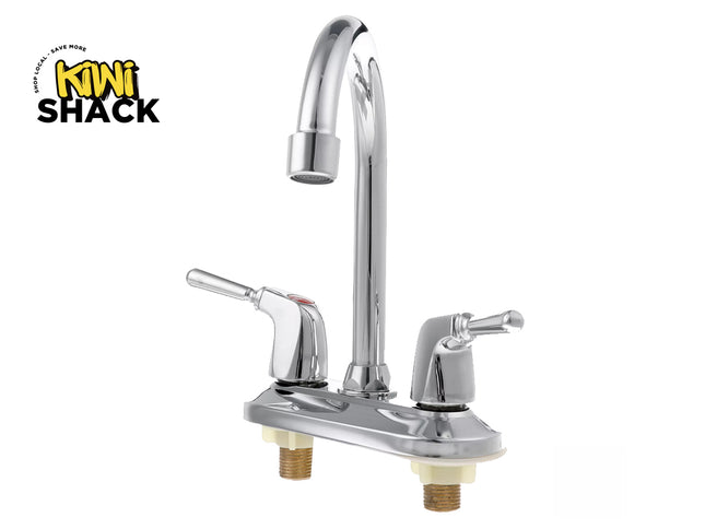 A polished chrome dual-handle kitchen faucet with a high-arc swivel spout and lever handles on an oval deck plate, featuring a "Kiwi Shack" logo in the top left corner.