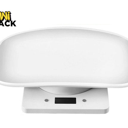 A white digital baby scale featuring a wide, curved weighing tray on top and a rectangular base with a digital screen and control buttons in the front, with a "Kiwi Shack" logo in the top left corner.