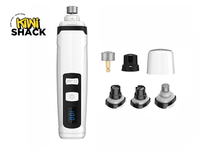 White and black electronic pet nail grinder / dog claw trimmer with digital LED display showing battery percentage (100), power button, "PRO" label, interchangeable grinding/safety heads and protective cap arranged to the side, and the Kiwi Shack logo watermark.