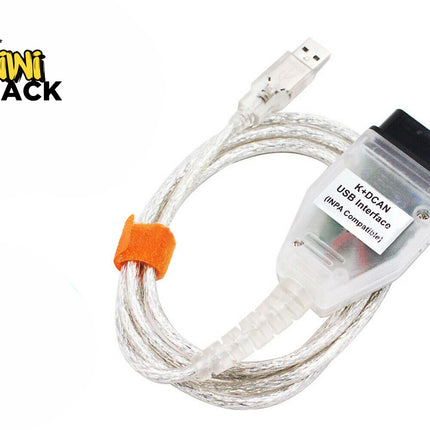 K+DCAN USB diagnostic interface cable (INPA compatible) with a transparent OBD2 diagnostic connector labeled "K+DCAN USB Interface (INPA Compatible)", a clear USB connector, coiled clear cable with an orange velcro cable tie, and the Kiwi Shack logo watermark.