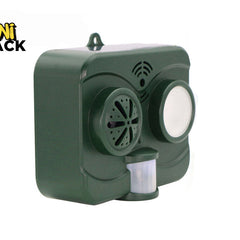 A dark green outdoor solar-powered animal repeller device featuring a motion sensor and speaker grille, with a "Kiwi Shack" logo in the top left corner.