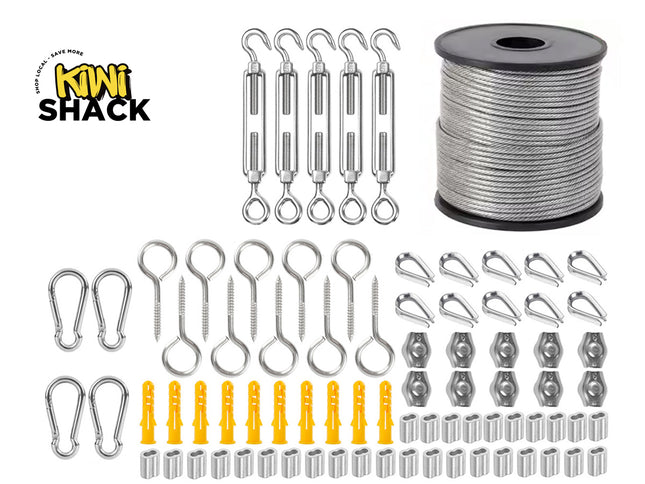 Stainless steel wire rope hanging and rigging hardware kit including a large spool of wire cable top right, five hook-and-eye turnbuckles, snap hooks, eye bolts, wire thimbles, rope clamps, yellow wall anchors, and aluminum crimping sleeves, with Kiwi Shack logo in top left.