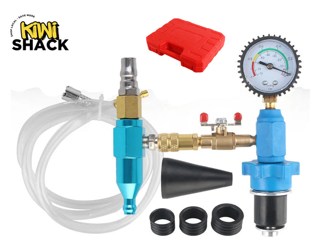 A pneumatic coolant vacuum purge and refill kit featuring a blue and silver manifold assembly with a circular pressure gauge, a coiled clear fluid hose, a black cone adapter with three additional rubber ring seals, and a red plastic storage case in the background, with a "Kiwi Shack" logo in the top left corner.