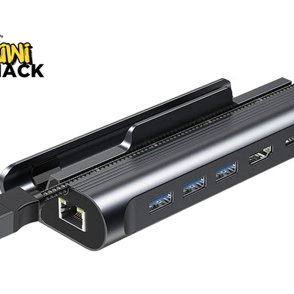 A black multi-port USB hub with an integrated power adapter, shown on a white background with a Kiwi Shack logo in the top-left corner.