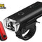 A black rechargeable bicycle headlight with an attached handlebar mounting bracket and a separate red LED rear tail light against a white background. A "Kiwi Shack" logo appears in the top-left corner.