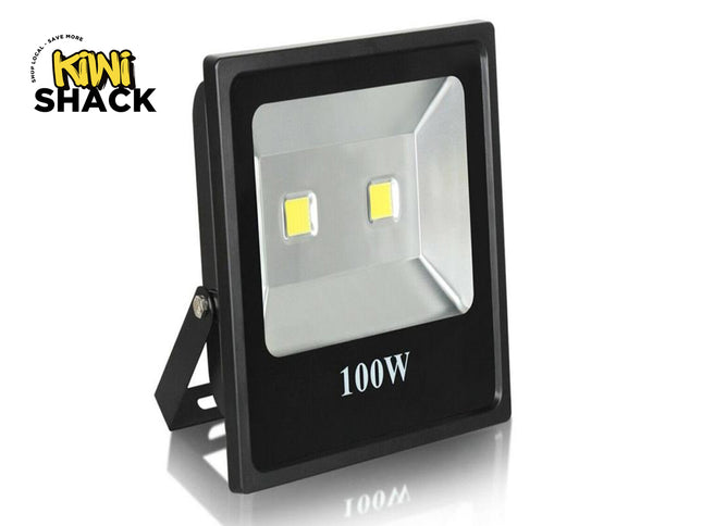 A 100W black outdoor LED floodlight with an adjustable mounting bracket, featuring the "Kiwi Shack" logo in the top-left corner.