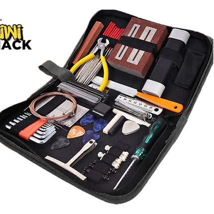 An open zippered black tool case containing various guitar maintenance and repair tools, including string cutters with yellow handles, hex keys, guitar picks, a string winder, a file, and a screwdriver, against a white background. A "Kiwi Shack" logo appears in the top-left corner.
