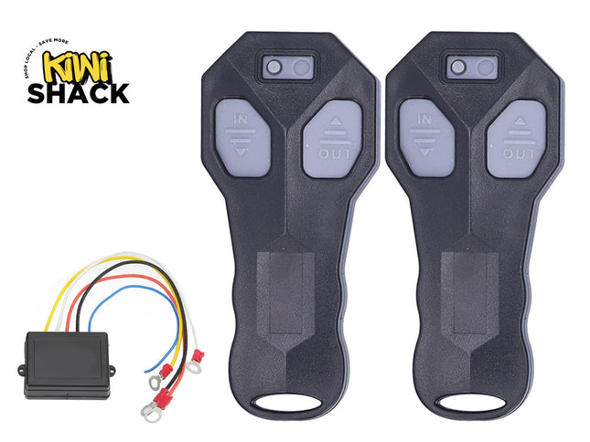 Two black wireless winch remote controls with grey "IN" and "OUT" directional buttons, shown with a matching black receiver module with multi-colored wiring harnesses and ring terminals on the bottom left, featuring Kiwi Shack logo in top left.