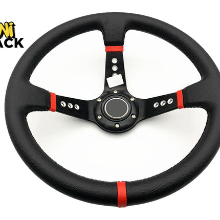 A black leather steering wheel with red accent stripes and a black center cap, shown on a white background with the Kiwi Shack logo in the top-left corner.