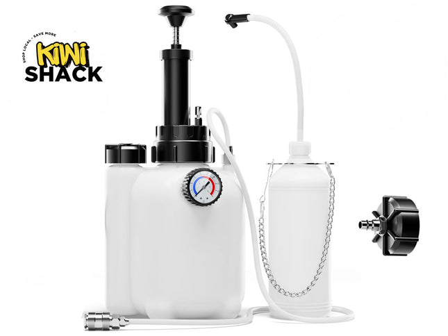 A manual brake fluid bleeder kit featuring white fluid reservoirs, a hand pump mechanism with a built-in pressure gauge, clear connecting hoses, a collection bottle with a hanging chain, and a replacement master cylinder cap adapter, set against a white background. A "Kiwi Shack" logo appears in the top-left corner.