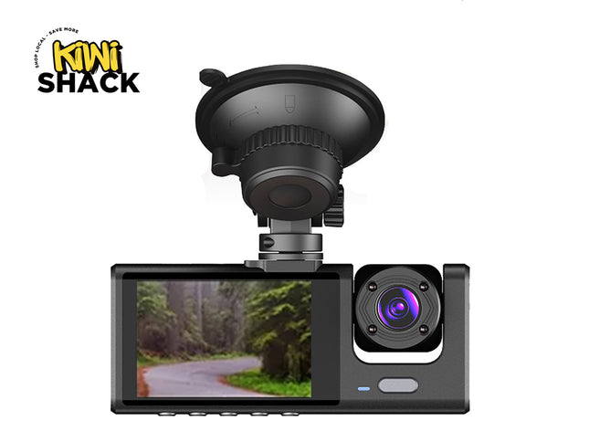 Car dashboard camera with screen displaying a road and trees, branded 'Kiwi Shack'.