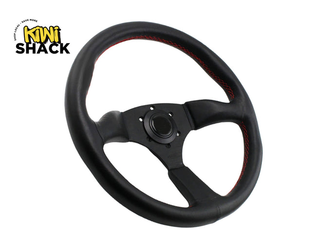 Black steering wheel with red stitching on a white background, featuring Kiwi Shack logo.