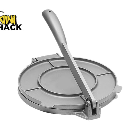 Metal tortilla press with a spoon on a white background, featuring the Kiwi Shack logo.