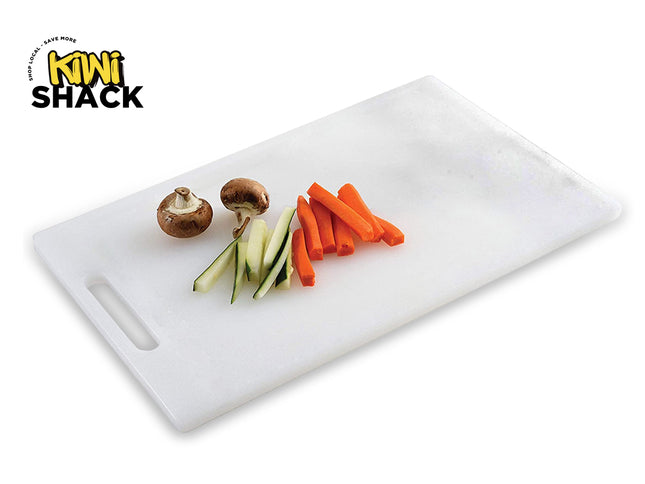 A white plastic cutting board with a handle slot, featuring sliced carrots, zucchini slices, and whole mushrooms, featuring the "Kiwi Shack" logo in the top-left corner.