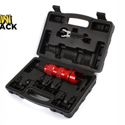 An open black molded plastic storage case containing a red metal tool and several black attachments, with a "Kiwi Shack" logo in the top left corner.