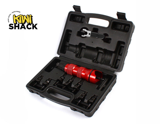 An open black molded plastic storage case containing a red metal tool and several black attachments, with a "Kiwi Shack" logo in the top left corner.
