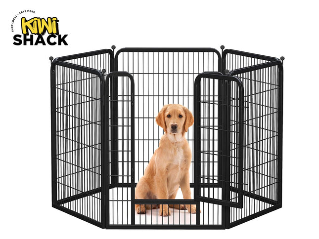 Dog inside a black metal pet playpen with 'Kiwi Shack' branding.