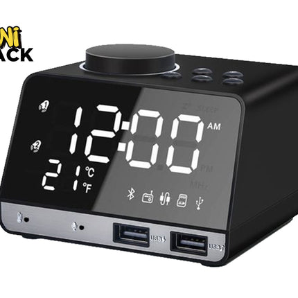 A modern black digital alarm clock radio with a large LED display showing the time and temperature, a top rotary volume dial, control buttons, and two front USB charging ports, featuring a "Kiwi Shack" logo in the top left corner.