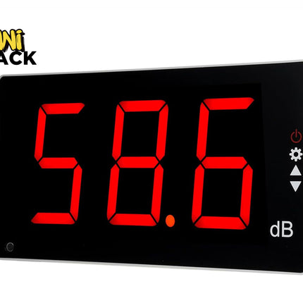 A digital decibel meter with a black face and large red LED numbers reading "58.6 dB" alongside control icons on the right, set against a white background with the "Kiwi Shack" logo in the top left corner.