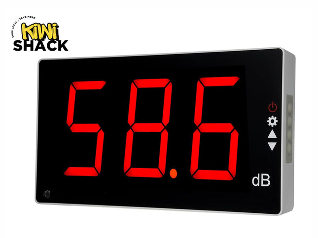 A digital decibel meter with a black face and large red LED numbers reading "58.6 dB" alongside control icons on the right, set against a white background with the "Kiwi Shack" logo in the top left corner.