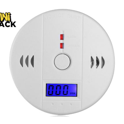 White round Smoke Alarm Detector with digital blue display reading 000 PPM, test/reset button, alarm and operate status indicator lights, side vent slots, "DO NOT PAINT" warning molded at the top, and Kiwi Shack logo in the top-left corner.