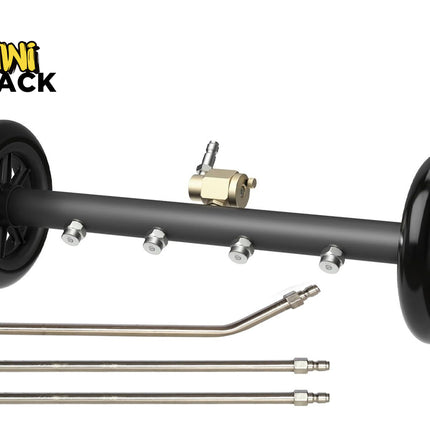 Product shot of a black undercarriage pressure washer attachment with two black wheels on either end, four stainless steel spray nozzles along the bar, a brass inlet valve with a quick-connect plug at the top center, and three extension wands placed underneath. The 'Kiwi Shack' logo appears in the top left corner.